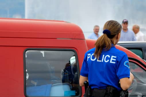 A police officer approaches the accident scene.