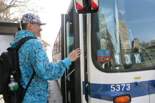 Man boards a Public Transportation bus.