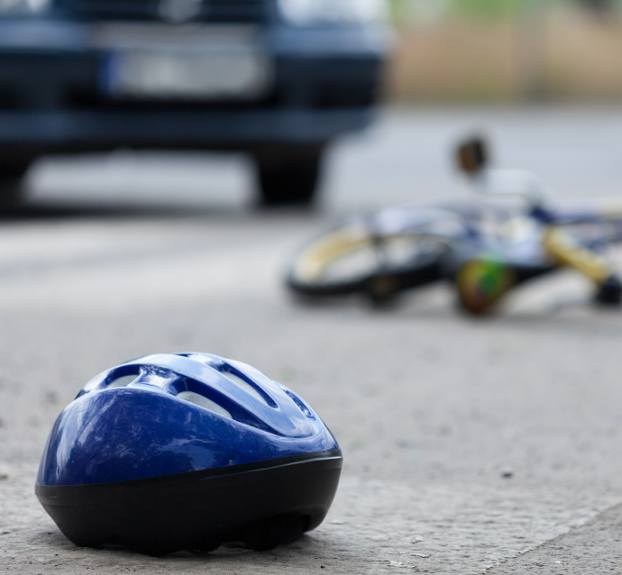 Scene of an accident appearing to be a child struck by a car on his bicycle, a common scenario of wrongful death lawsuits in Chicago
