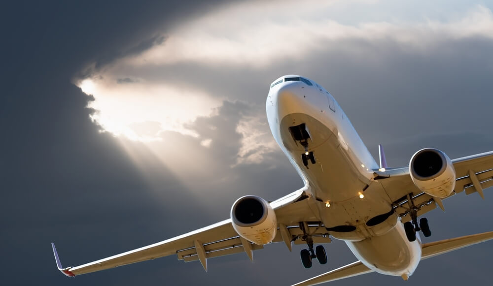 Airplane flying into storm clouds, symbolizing potential risks and causes of aviation accidents in Chicago.