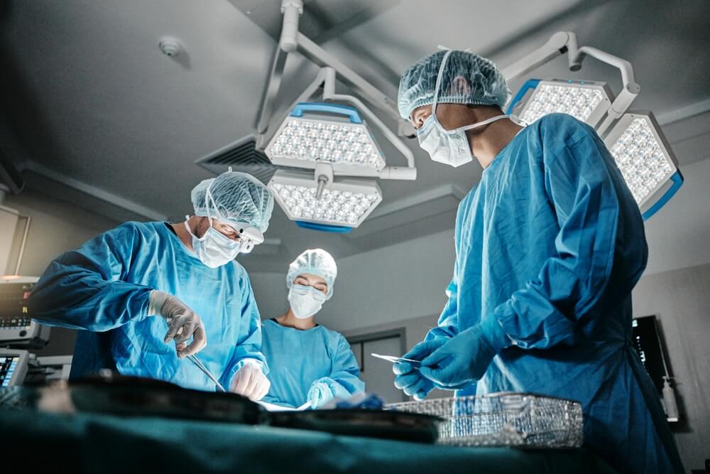 Surgeons performing operation in sterile operating room – risk of nerve damage during surgery