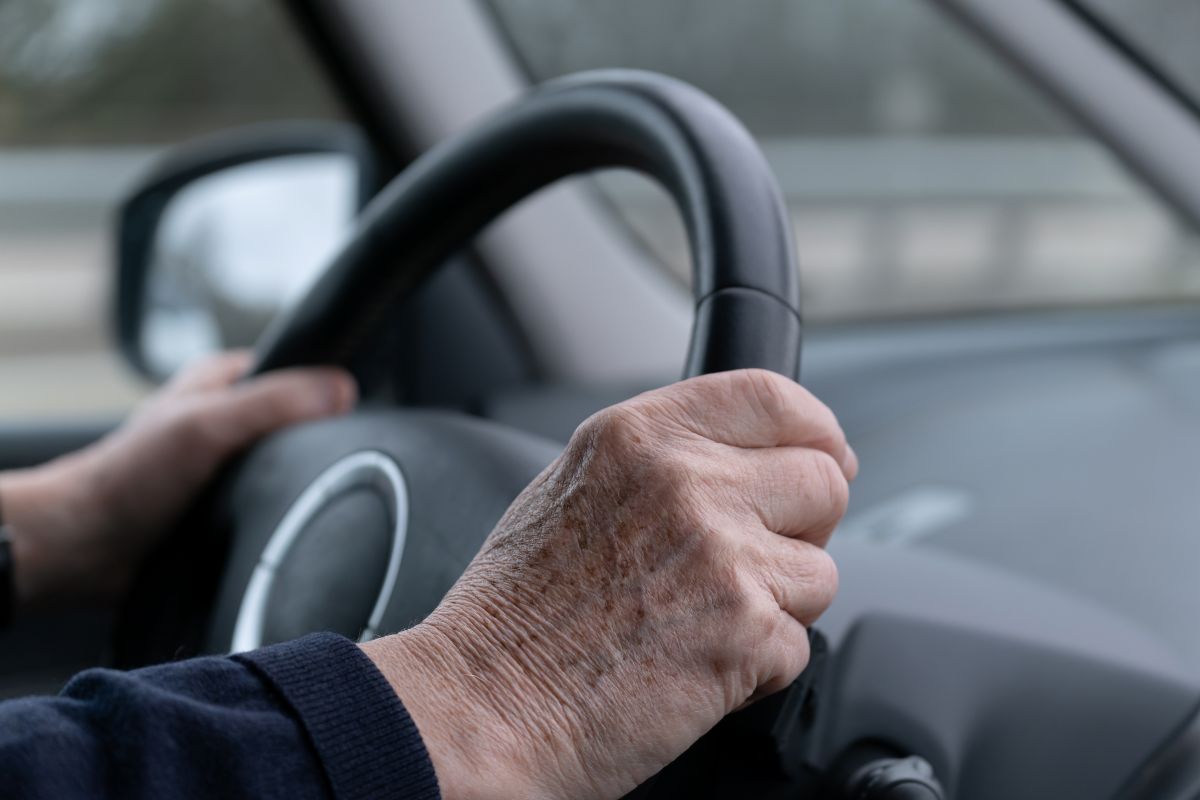 elderly person driving a vehicle