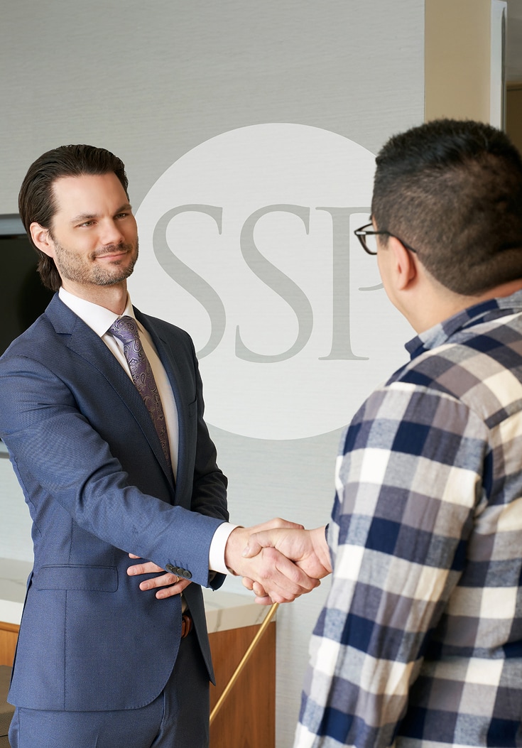 Photo of an attorney and a client shaking hands